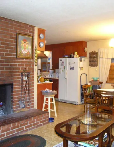 A brick fireplace in a living room.