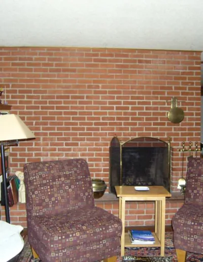 A brick fireplace in a living room.