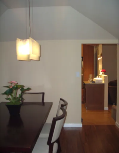 A dining room with a table and chairs.