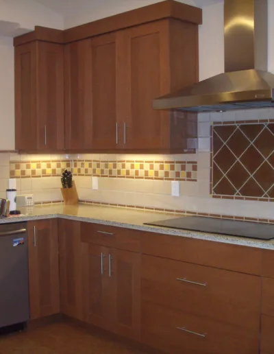 A kitchen with brown cabinets.