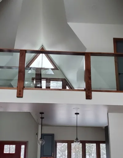 A home with an attic and a glass railing.