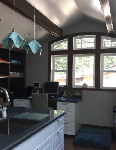 A kitchen with a refrigerator and a sink.