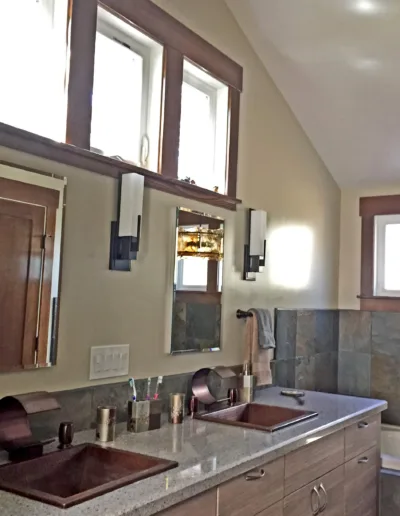 A bathroom with two sinks and a tub.