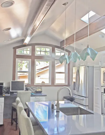 A kitchen with a large island and a skylight.